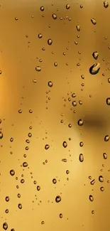 Golden droplets on glass with a soft, luminous background.