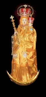 Golden religious statue with child against black background.