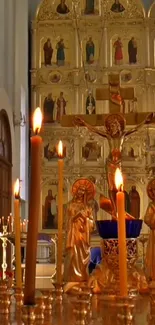 Golden religious scene with candles and icons.