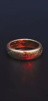 Majestic gold ring with fiery glow on dark background.