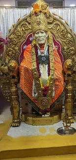 Sai Baba golden shrine with vibrant decorations in spiritual setting.