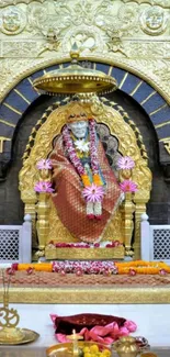 Golden Sai Baba shrine adorned with flowers and intricate designs.