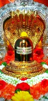 Golden Shiva lingam adorned with flowers and ornate design.