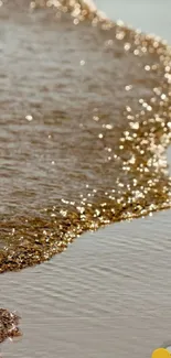 Golden waves softly lap against the sandy beach, creating a serene and tranquil scene.