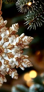 Close-up of a festive snowflake ornament with gold accents on a Christmas tree.