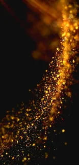 Abstract image with golden sparkles on a dark background.