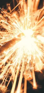 Dynamic golden sparkler explosion on dark background wallpaper.