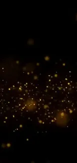 Golden sparkling particles on a black background wallpaper.