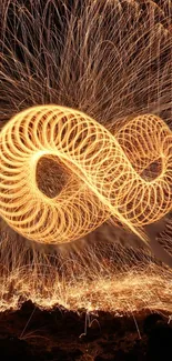 Golden spirals light painting wallpaper with sparks.