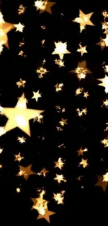 Golden stars glowing on dark night sky wallpaper.