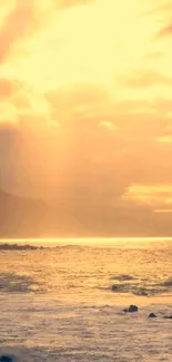 Golden sunset over ocean with beach view.