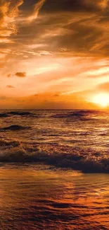 Golden sunset over ocean waves and sandy beach.