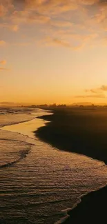 Golden sunset over a peaceful beach with gentle ocean waves.