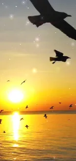 Golden sunset with birds over a calm ocean.