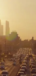 Cityscape at sunset with golden sky and traffic.