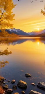 Golden sunset over mountain lake with autumn trees.