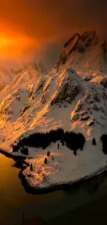 Golden sunset over snowy mountains with orange sky.