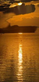 Golden sunset over an ocean with serene reflections.