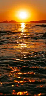 Golden sunset reflecting on ocean waves.