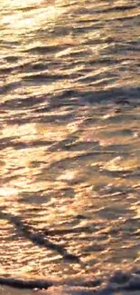 Mobile wallpaper of golden ocean waves at sunset with shimmering reflections.