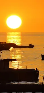 Golden sunset with silhouetted boats on calm waters.