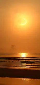 Golden sunset over a calm ocean with reflecting light.