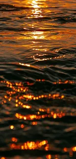 Golden sunset reflection on rippling water.