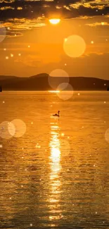 Golden sunset reflecting over a tranquil lake with a silhouetted bird.