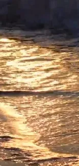 Golden sunset reflecting on ocean waves, creating a serene, warm scene.