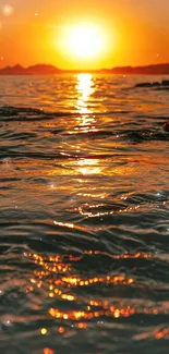 Golden sunset casting reflections over ocean waves.