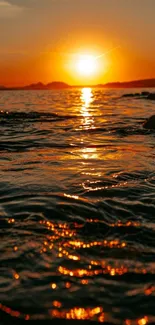 Sunset casting golden light over ocean waves.