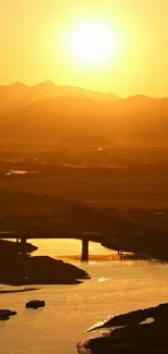 Golden sunset over a serene riverside landscape.