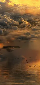 Golden sunset with birds over calm, reflective waters and cloudy sky.