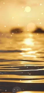 Golden sunset with bokeh effect over calm water.