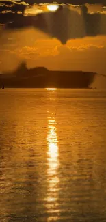 Golden sunset reflecting over calm waters under a cloudy sky.