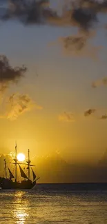 Golden sunset over the ocean with a ship silhouette.