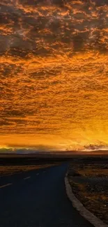 Open road at sunset with orange sky and dramatic clouds.