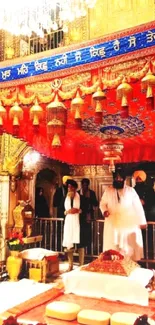 Sikh Golden Temple interior with red canopy and sacred decor.