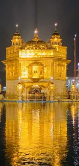 Golden Temple reflecting beautifully at night over calm water.