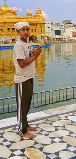 A person meditating by the Golden Temple's reflection on water.