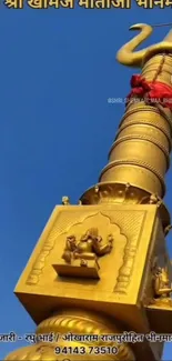 Golden tower set against a bright blue sky in an artistic wallpaper.