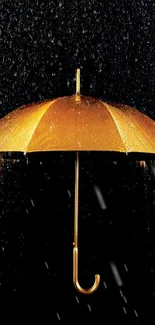 Golden umbrella glistening under rain on a dark background.