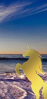 Golden unicorn silhouette at ocean sunset beach.