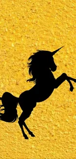 Black unicorn silhouette on golden texture wallpaper.