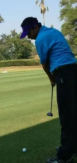 Golfer ready to swing on lush green course.