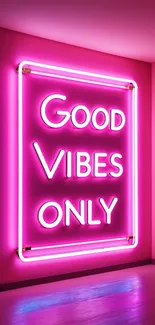 Pink neon sign reading 'Good Vibes Only' on a wall.