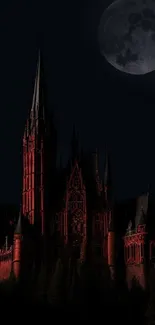 Gothic castle illuminated in red under a full moon at night.