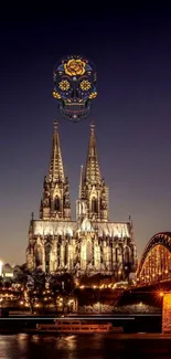 Gothic cathedral lit at night with a colorful sugar skull.