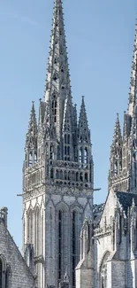 Gothic cathedral spires against a blue sky.