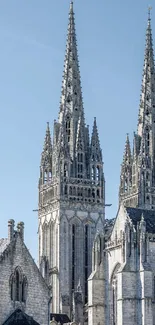 Gothic cathedral spires with a blue sky backdrop.